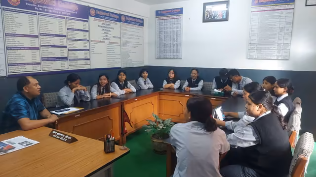 Students in uniform seated along a broad wooden table below walls of notice boards