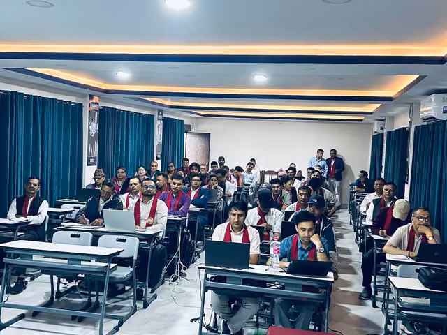 Students at desks filling a lecture room with a panelled ceiling