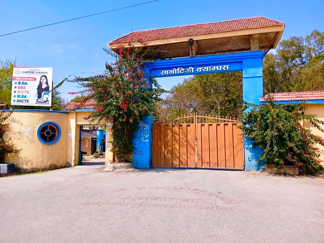 The campus gate in blue and orange, सानोठिमी क्याम्पस lettered across the arch